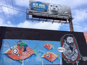 Unable to figure out transportation between the BoltBus stop and Budget Car Rental, I had to walk a mile and a half down a mostly uninspiring stretch of road. My reward was finding this painted wall and seeing harmony between it and the billboard above it.