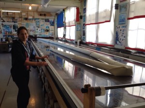 This long table is perforated with holes and can 'suck' the fabric to keep it flat.